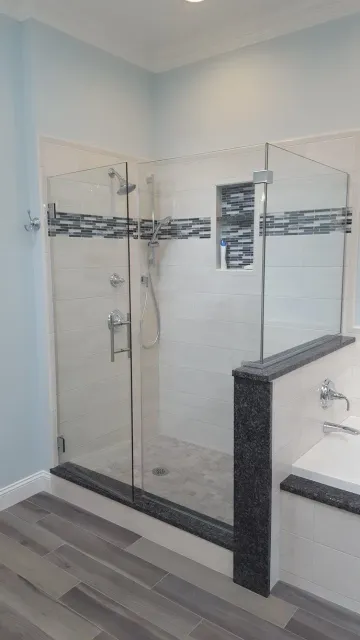 A bathroom with a walk in shower and a bathtub.