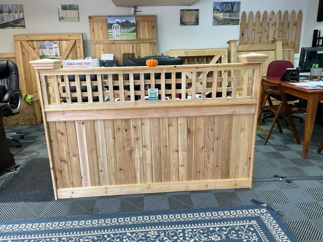 A wooden fence is sitting in a room next to a table and chairs.