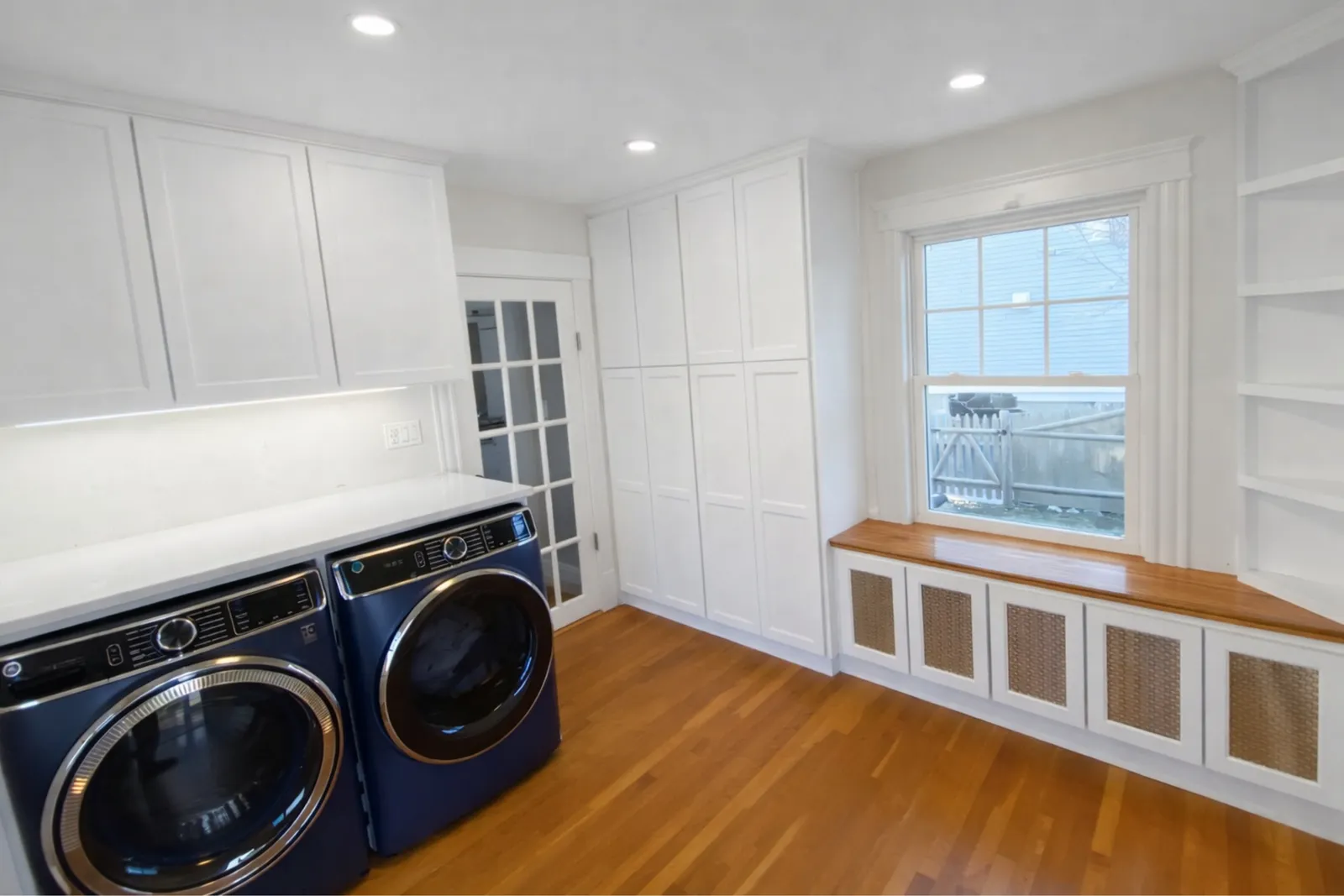 Custom laundry room with built-in cabinetry by Marblehead Carpentry