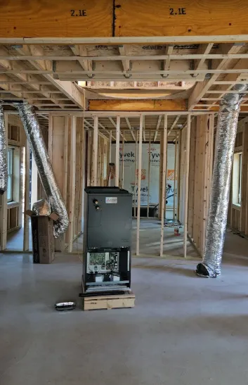 New HVAC air handler and ductwork installed during home construction