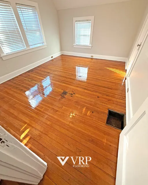 Wide plank flooring installed across an open living space