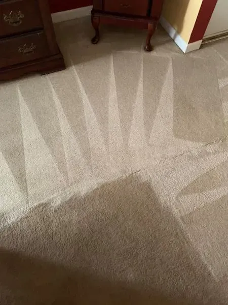 a close up of a carpet in a room with a nightstand