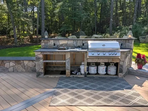 Outdoor kitchen with built-in grill, stone countertop