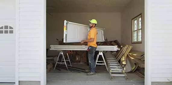 garage door technician installing garage door panels