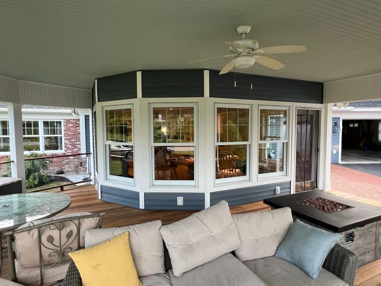 A living room with a lot of windows and french doors.