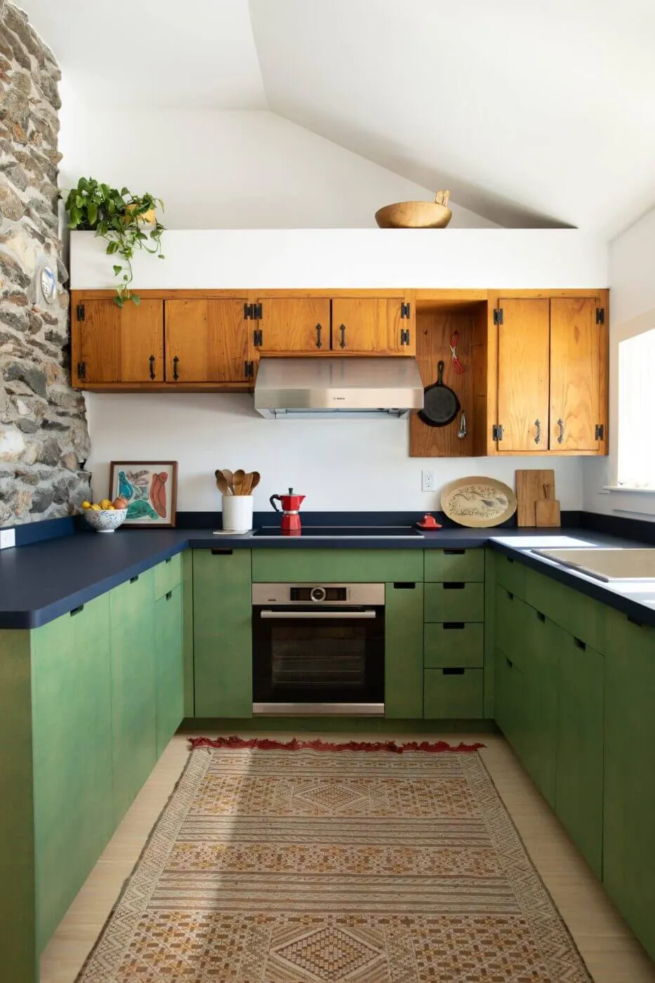 modern kitchen renovation fireplace with wrap around cabinetry rustic kitchen remodel with modern green plywood kitchen cabinets on bottom and original historic wood upper cabinets in Shelburne, MA