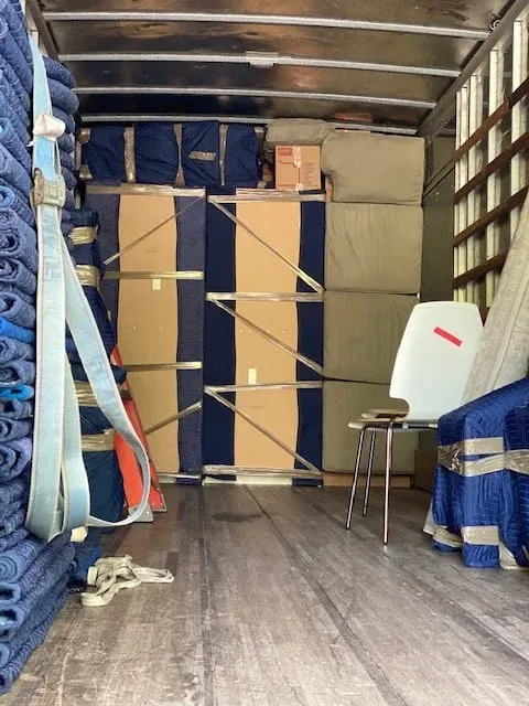 Moving company team preparing boxes and equipment for a residential move