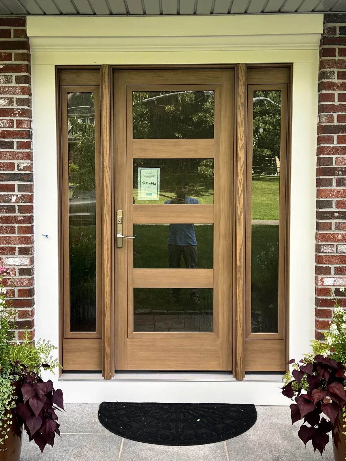 Natural wood entry door with matching sidelights