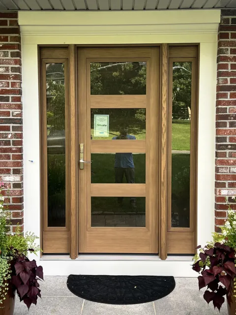 Natural wood entry door with matching sidelights