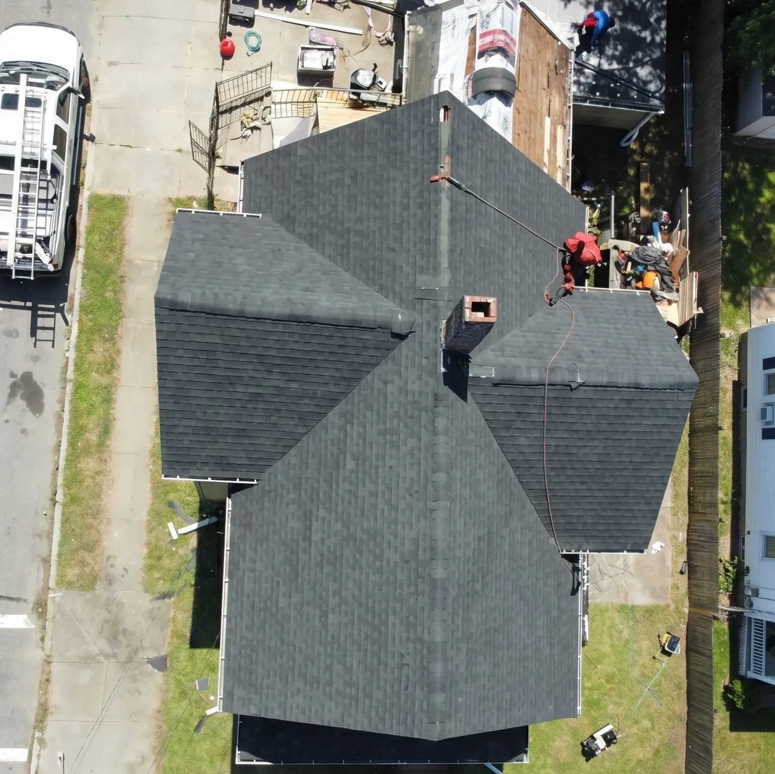 Aerial view of a newly installed dark architectural asphalt shingle roof on a Massachusetts home by Jennifer Construction