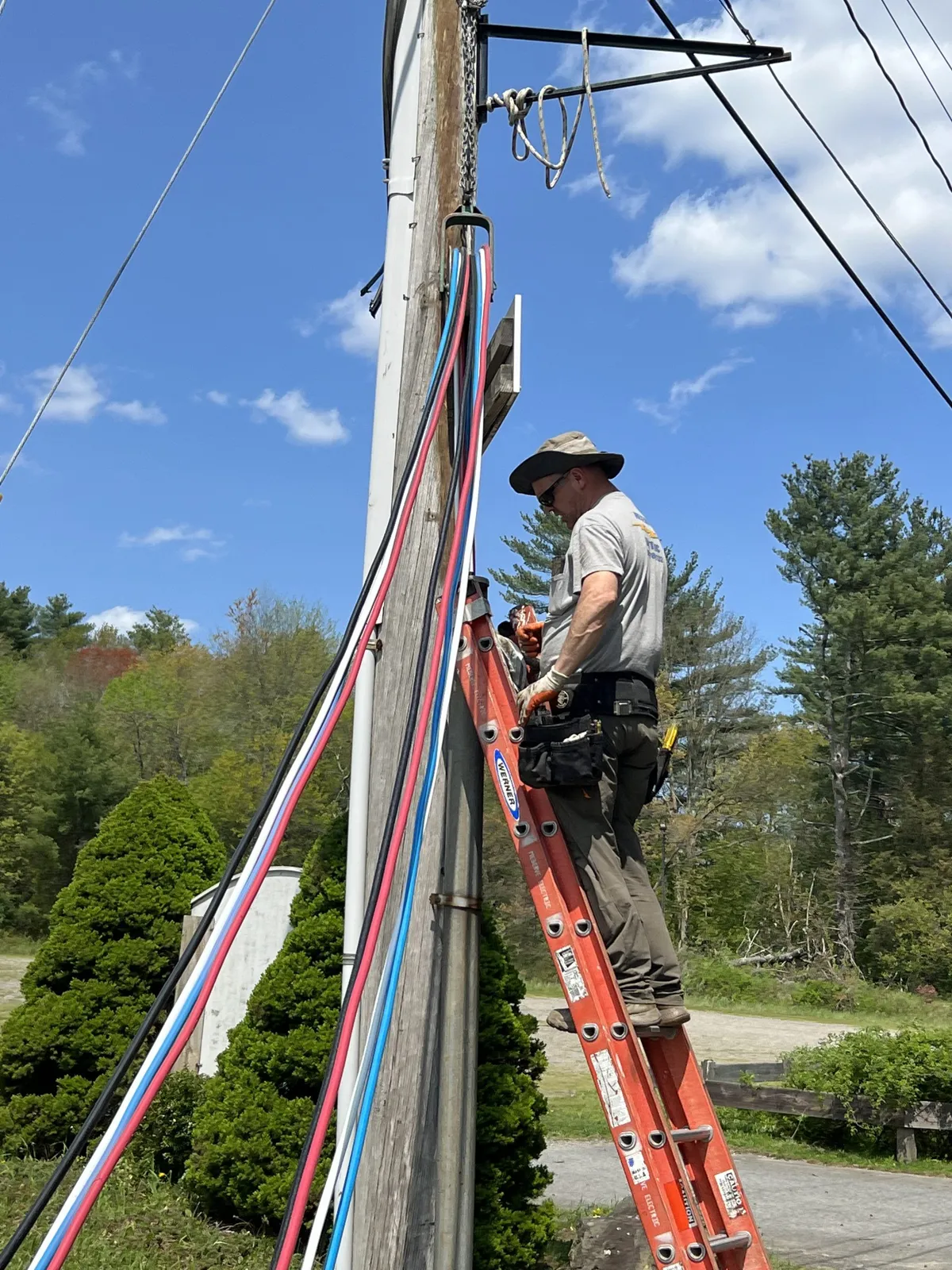 Electrician performing pole and outdoor electrical line installation