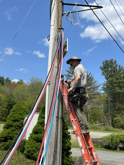 Electrician performing pole and outdoor electrical line installation