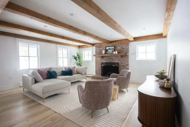 Living room with painted trim and exposed beams