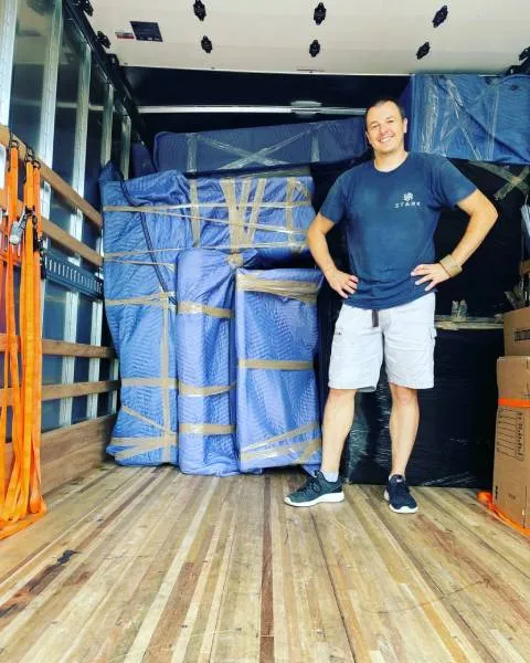 mover in amoving truck smiling