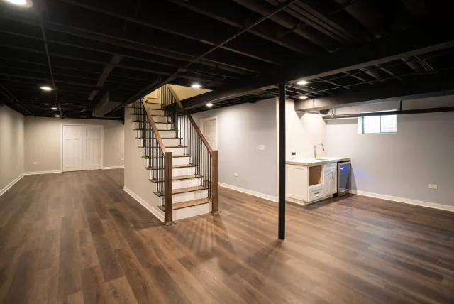 Finished basement with wood-look flooring, new lighting and open staircase