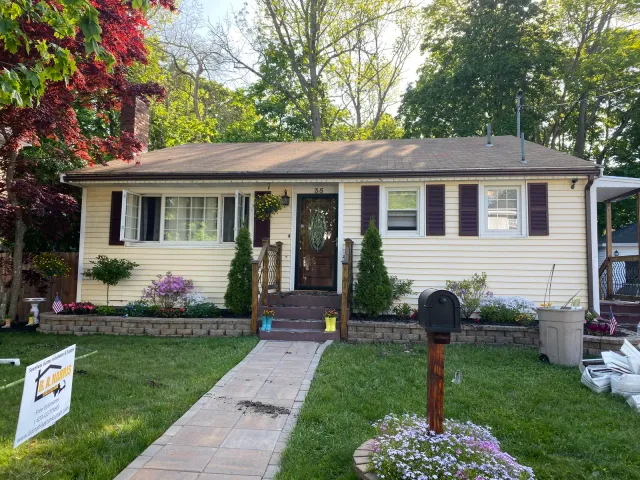 Single-story ranch home with freshly installed seamless gutters in Massachusetts