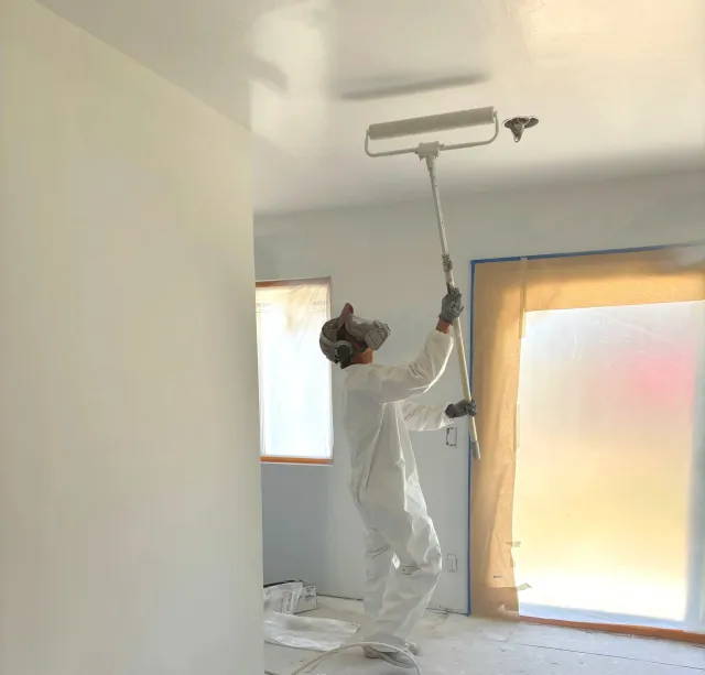 Back-rolling ceiling for flawless finish on renovation and painting project in Newburyport, Massachusetts