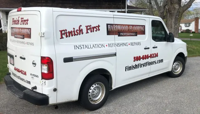 Finish First Hardwood Flooring lettered work van with information advertising installation, refinishing, and repairs