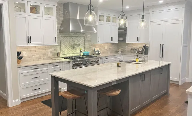 A kitchen updated with new cabinets, counters and backsplash