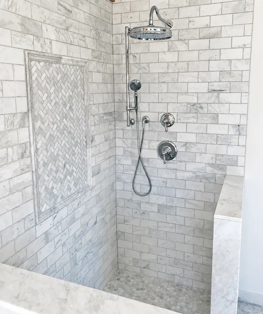 Bright marble shower and custom bathroom remodeling project by KBK Woodworking