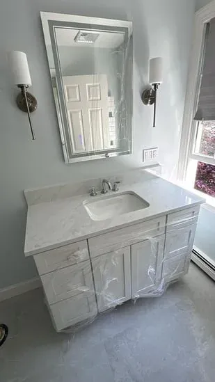 Side view of an Imperiali Grey Quartz Acton project featuring a custom countertop and integrated sink.