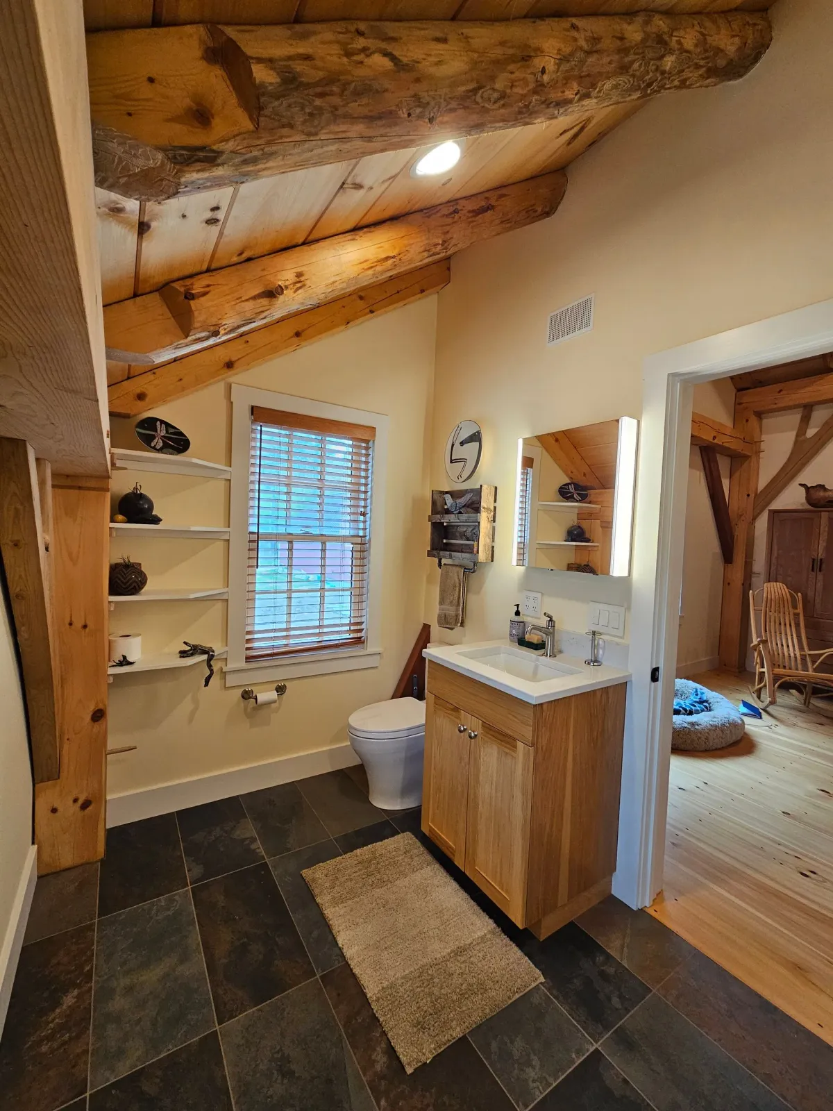 A bathroom with a toilet , sink , and mirror.