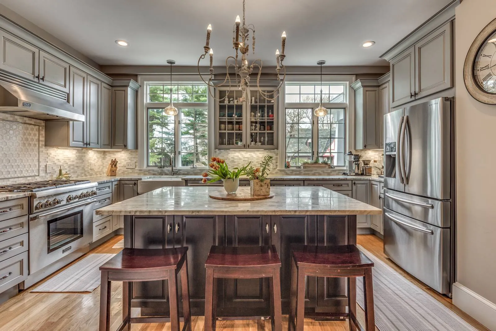 Symmetrical kitchen design in Winchester, MA by Pegasus Design-to-Build showcasing a central island and custom cabinetry-optimized