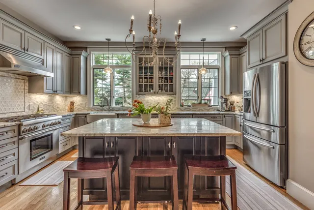 Symmetrical kitchen design in Winchester, MA by Pegasus Design-to-Build showcasing a central island and custom cabinetry-optimized