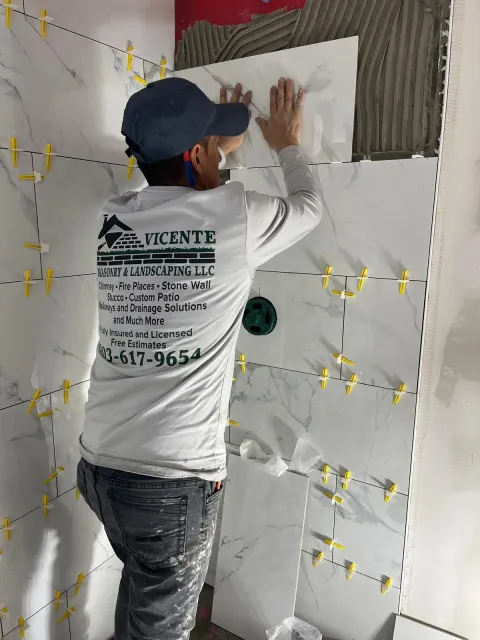 Vicente Masonry team working on a custom stone wall in Connecticut
