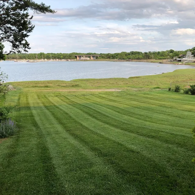 Wide waterfront lawn mown in stripes