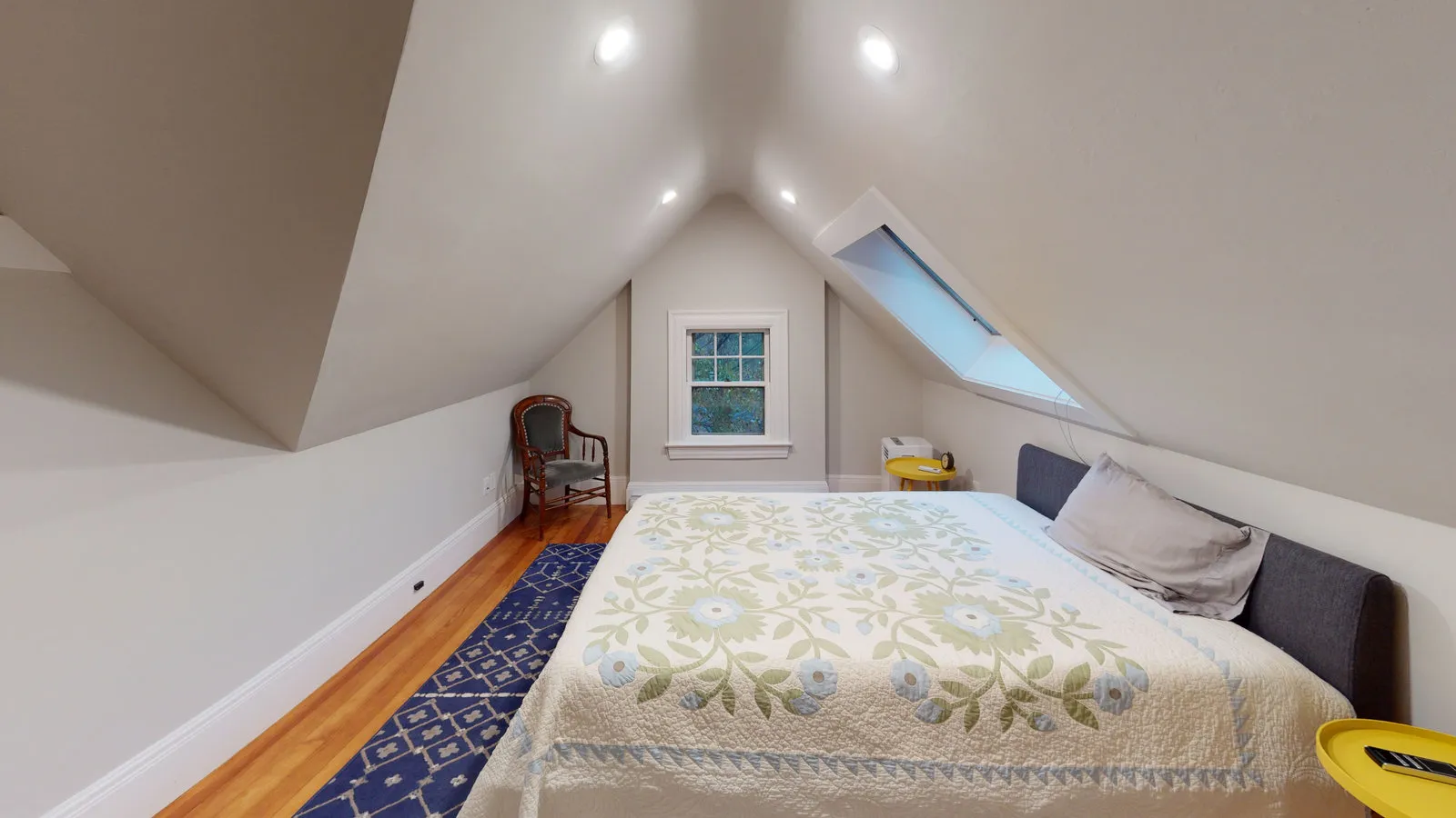 Top-floor bedroom under the gable with skylight
