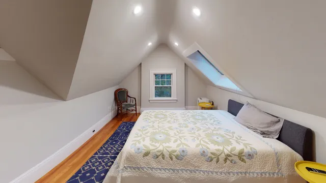Top-floor bedroom under the gable with skylight