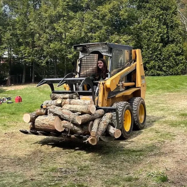 MacKenzie on the CASE skid steer clearing logs for MacKenzie Tree, LLC