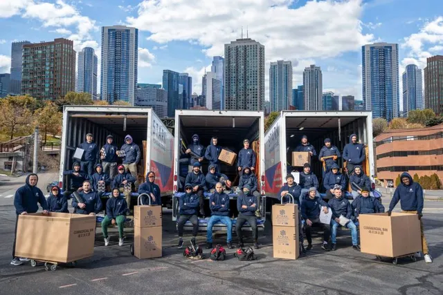 stark movers inside their moving trucks, while having boston skyline in the background