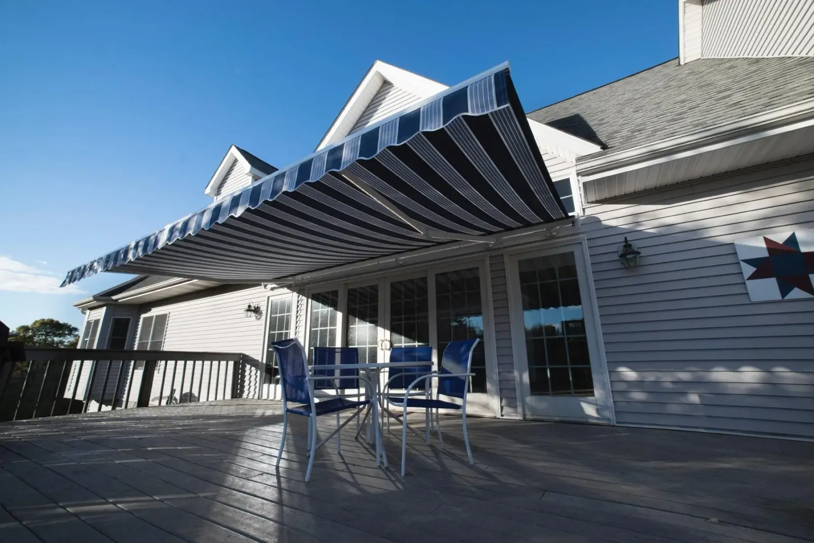 CJM Builders Motorized retractable awning on a cape home deck