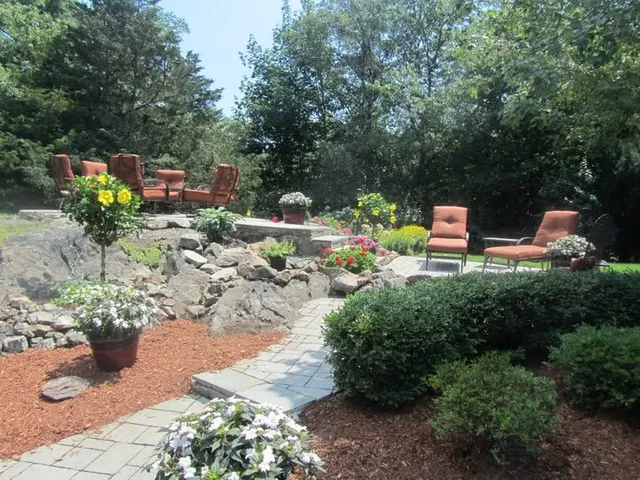 Finished patio and stone walkway with mature plantings
