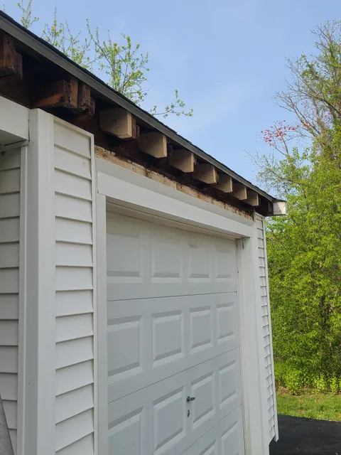 Rotted fascia exposed on garage before repair