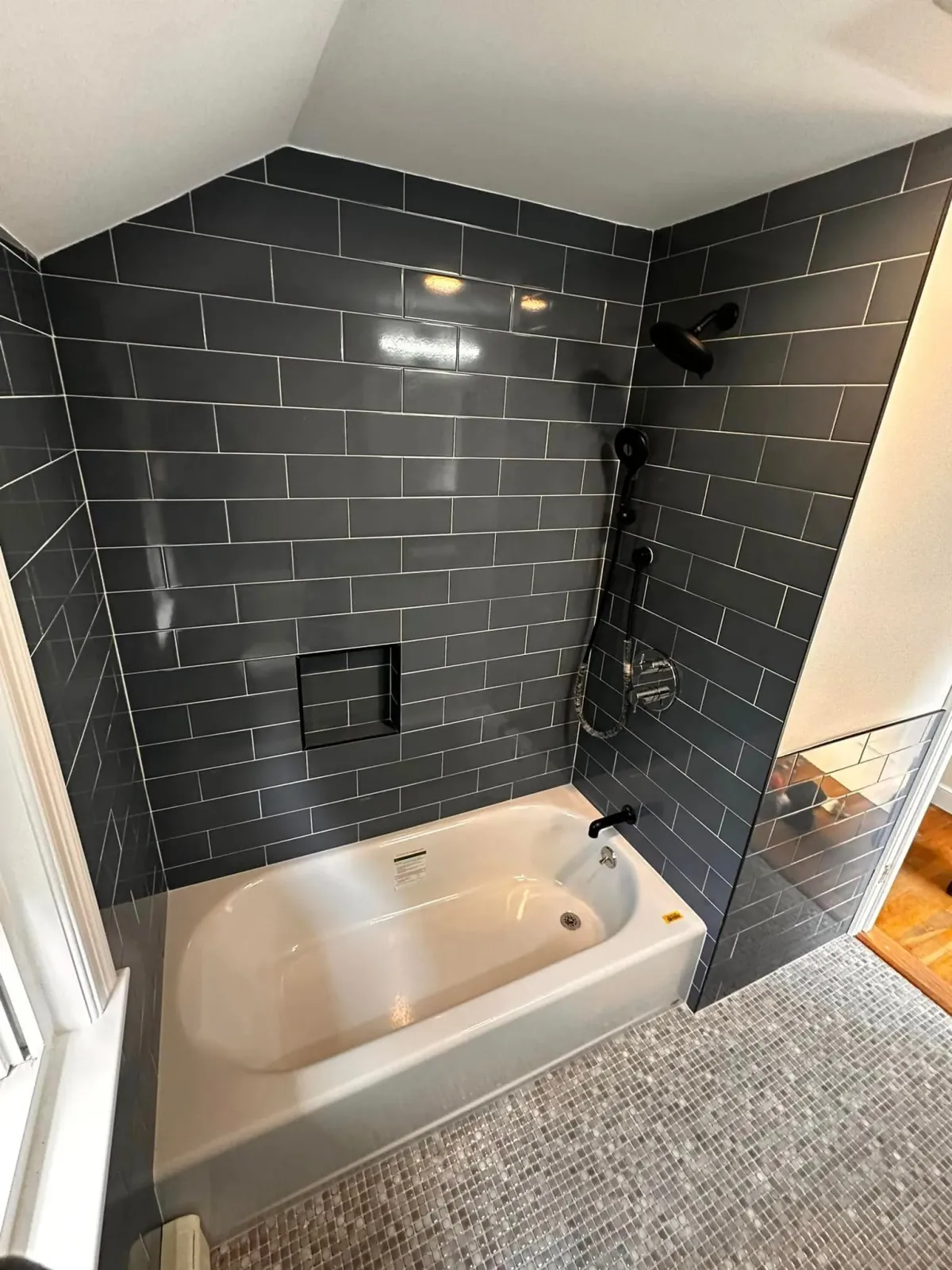 A bathroom with a bathtub and a shower.
