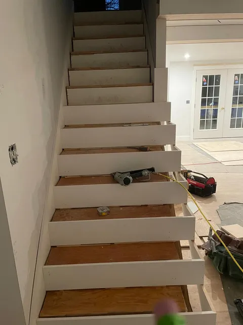 Photo of a staircase with high-quality wood flooring installed by Victor's Finish Work