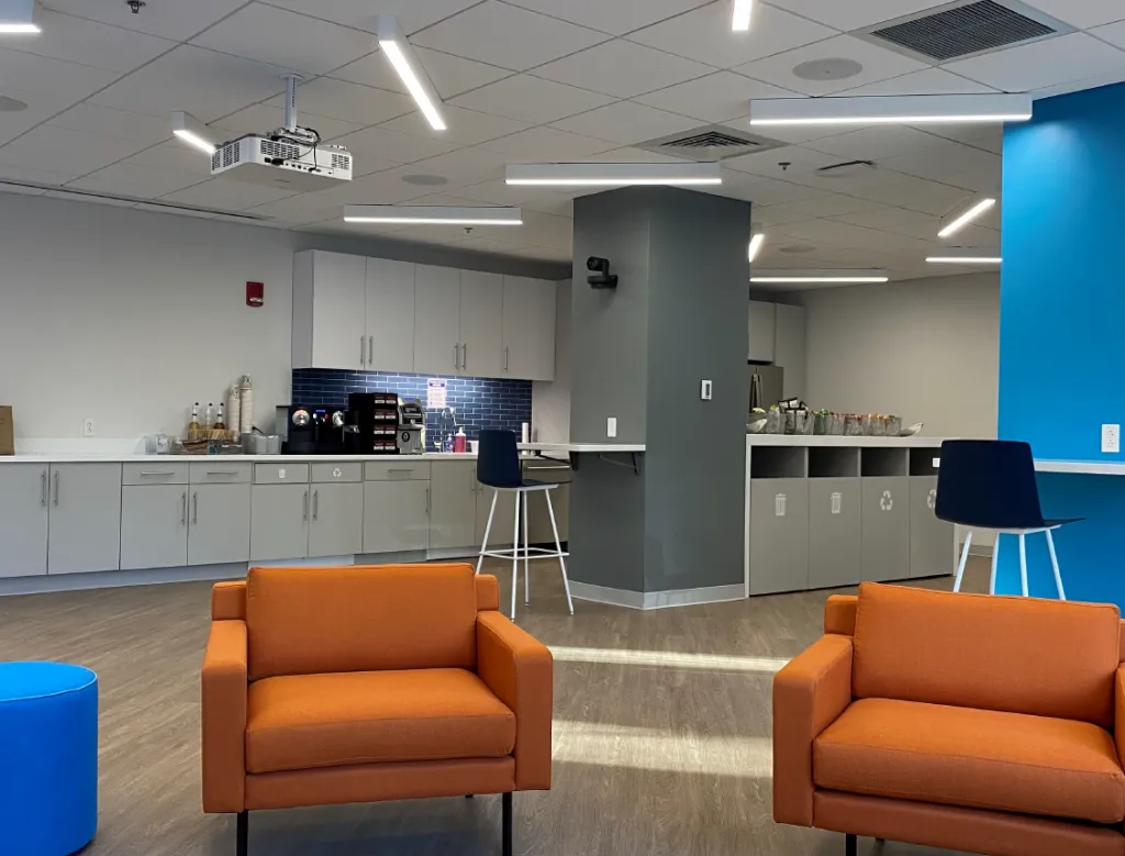 Rheos Medicine’s new Cambridge headquarters located at 245 First St. utilized existing lab office infrastructure to maximize their budget value. Approx. 20,000SF of existing lab and office space was modified and updated to fit Rheos’ program needs.  Their new facility consists of a large open general lab space in addition to Tissue Culture and Mass Spec suites.  In addition to private office and conference rooms,  their large open office space allows for a dynamic and flexible work environment.  While their Café doubles as a presentation space for larger meetings or gatherings.