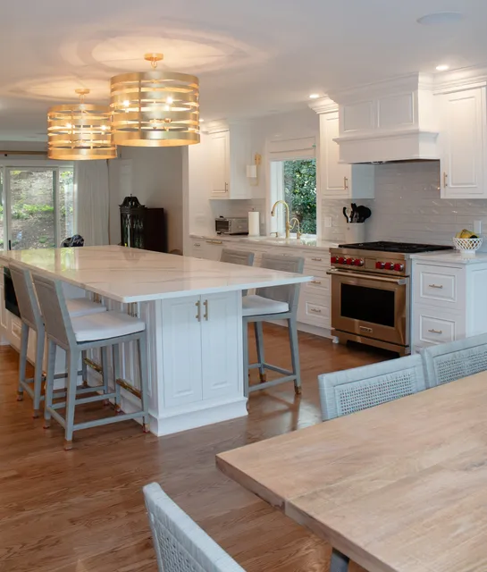 Kitchen with two-tone cabinetry, island seating and pendant lighting