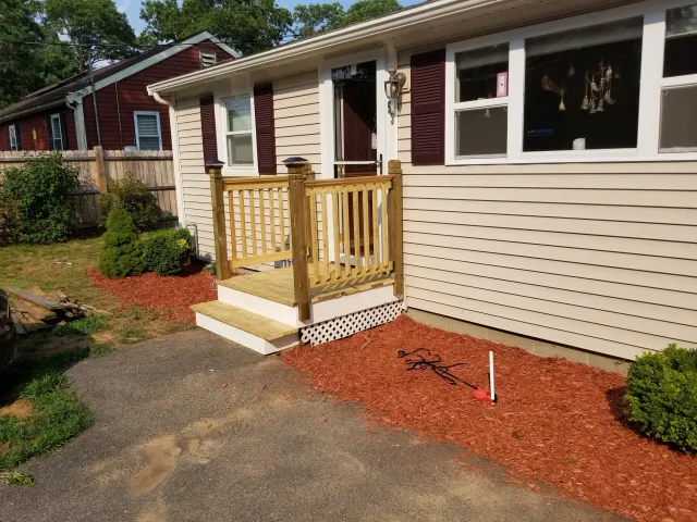 After of before picture, showing A new larger front step/small deck and railings, brand new nice pressure treated wood being used.