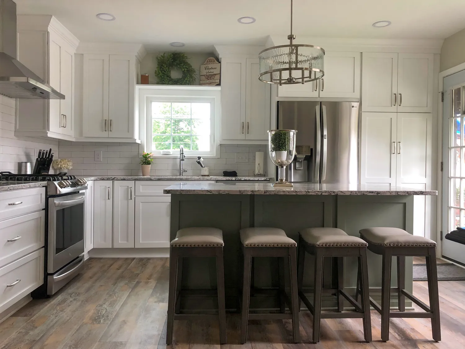 Haute Designs Kitchen & Bath. 
Shaker style Designer’s Choice cabinetry – Perimeter painted Radiant White; Island painted Sage. Spice rack pull-out, double crown molding, under cabinet lighting. 


Custom kitchen design by Haute Designs Kitchen & Bath.