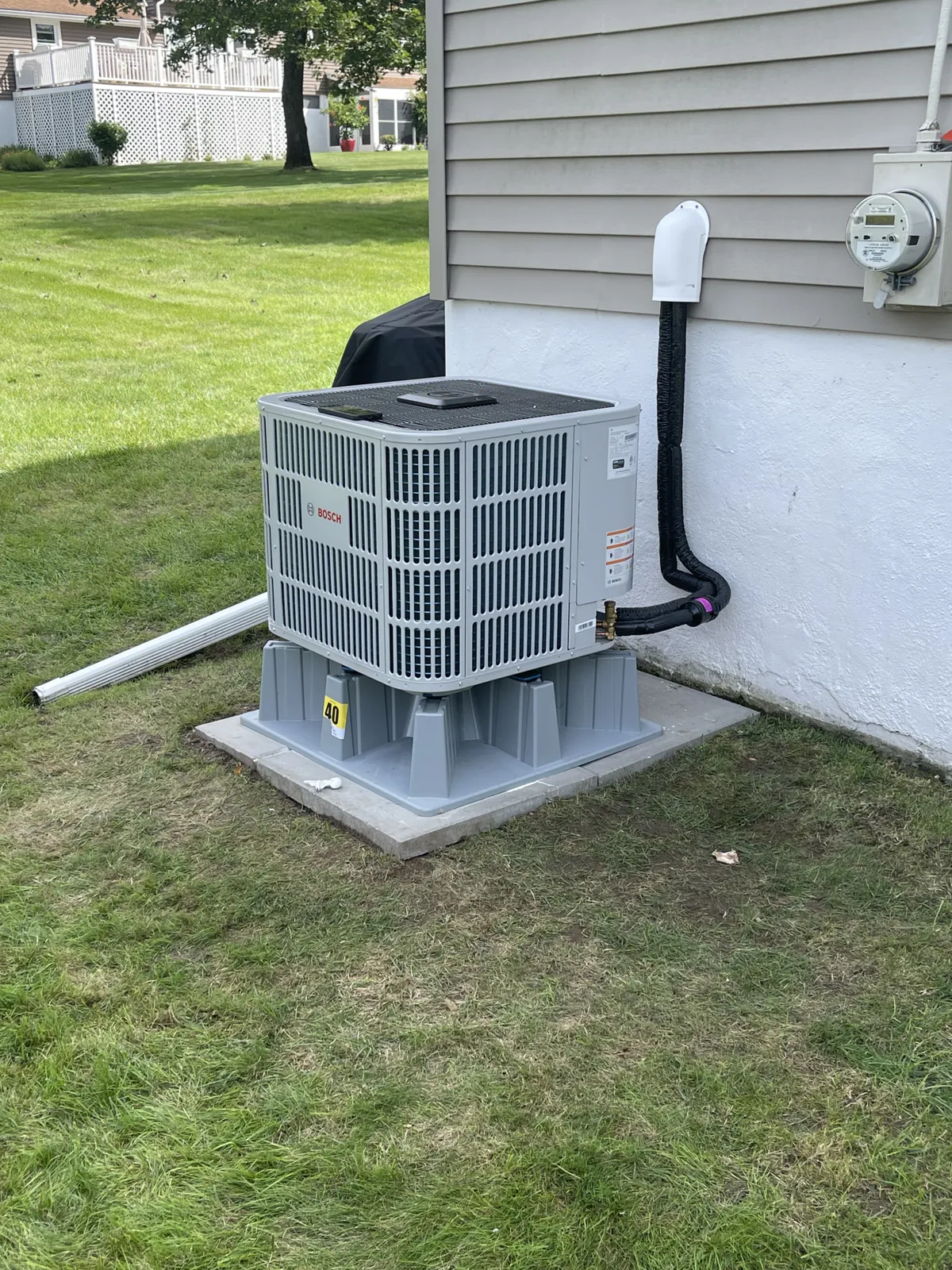 Bosch heat-pump condenser set on a pad for a whole-home install