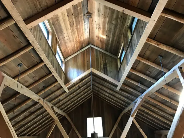 Looking up at the ceiling of a wooden building.