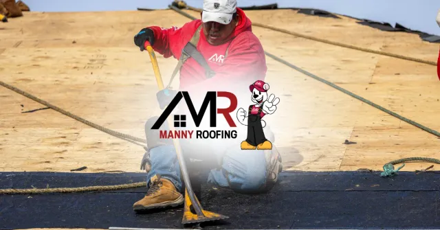 Worker in red jacket using a broom on a roof with Manny Roofing logo.
