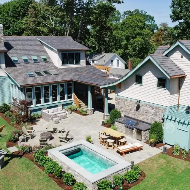 An aerial view of a house with a large swimming pool