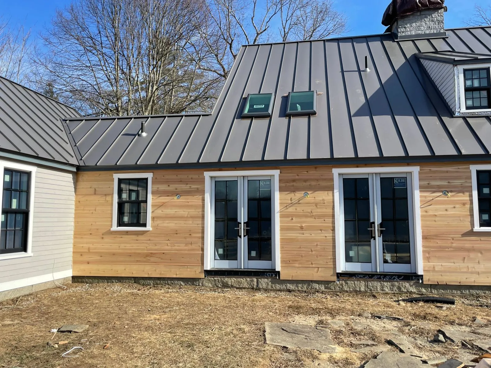 Home addition with cedar siding and metal roof