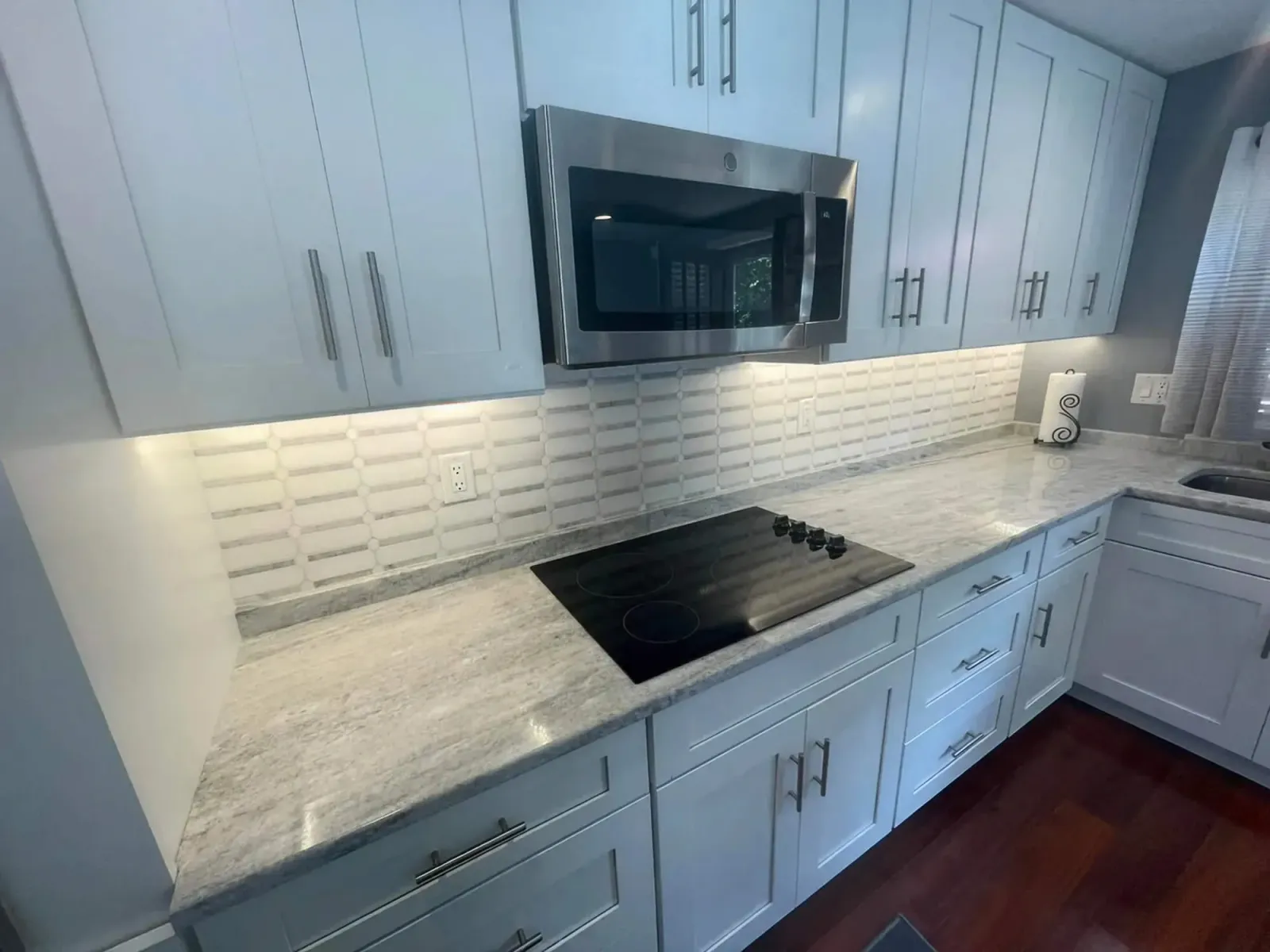 Custom white cabinets in a clean white kitchen