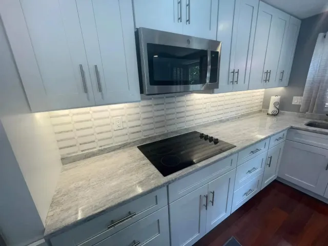 Custom white cabinets in a clean white kitchen